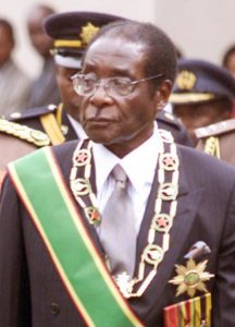 Robert Mugabe, in his role as President of Zimbabwe (wearing not quite as many medals as Idid Amin, but he's trying)